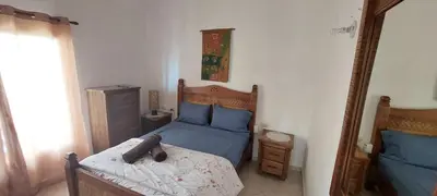 a small bedroom with a bed and a mirror at Tamarindo in Bayahibe