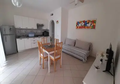 a kitchen and living room with a table and chairs at Tamarindo in Bayahibe