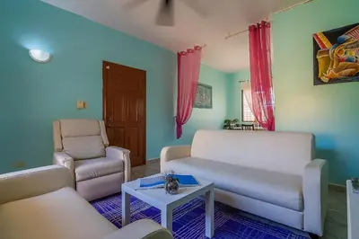 a living room with two couches and a table at D'Piero Hotel in Sosúa