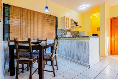 a dining room with a table and chairs in a kitchen at D'Piero Hotel in Sosúa