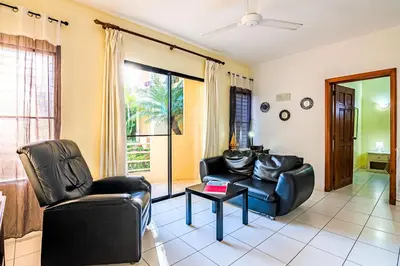a living room with two leather chairs and a table at D'Piero Hotel in Sosúa