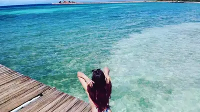 a person laying on a dock in the water at Villa Elegante y Familiar en Pedernales, Cerca de la Playa del pueblo, Residencial SFA in Pedernales