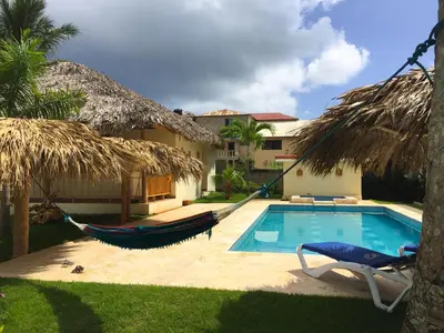 a resort with a hammock and a swimming pool at Las Galeras Hotel in Las Galeras
