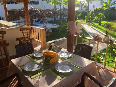 a table with a plate of food on a patio at Las Galeras Hotel in Las Galeras