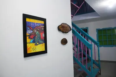 a picture of a lizard on a wall next to a staircase at Hostal Johnnier Macao Punta Cana in Punta Cana
