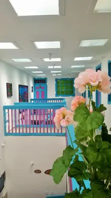 a room with a crib with pink flowers at Hostal Johnnier Macao Punta Cana in Punta Cana
