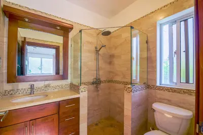 a bathroom with a shower and a toilet and a sink at House 24 in Casa Linda in Sosúa