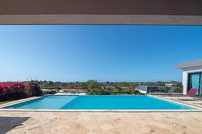 a swimming pool with a view of a house at House 24 in Casa Linda in Sosúa