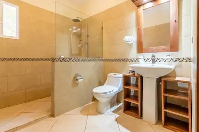a bathroom with a toilet and a sink at House 24 in Casa Linda in Sosúa