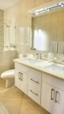 a bathroom with a sink and a toilet and a mirror at House 24 in Casa Linda in Sosúa