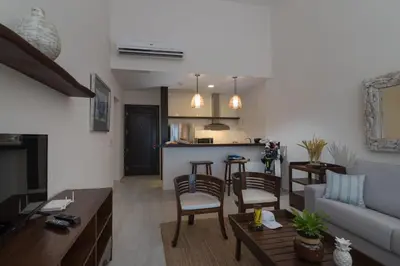 a living room with a couch and a table at Hotel Casa Hemingway in Juan Dolio