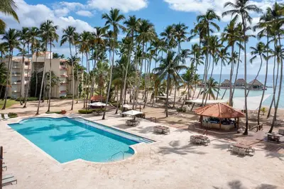 an aerial view of a resort with a pool and palm trees at Hotel Casa Hemingway in Juan Dolio