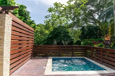 a swimming pool with a wooden fence and a wooden fence at Hotel Gran Jimenoa in Jarabacoa