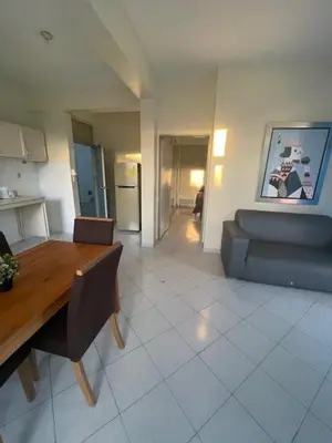 a living room with a table and a couch at Hotel Costa Linda Beach Boca Chica in Boca Chica