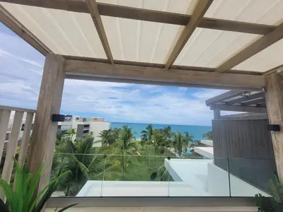 a view of the ocean from the balcony of a resort at Seawinds Studio - Beachfront Getaway in Cabarete
