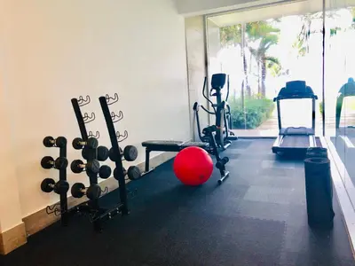a gym with a red ball and some exercise equipment at Seawinds Studio - Beachfront Getaway in Cabarete