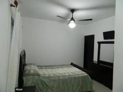 a bedroom with a bed and a ceiling fan at Residencial Vista Del Bosque in Santiago de los Caballeros