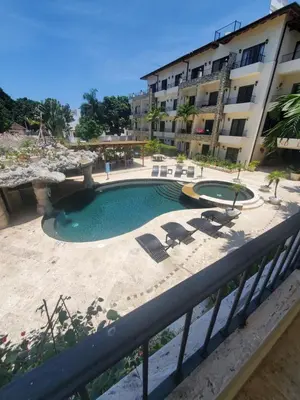 a swimming pool in front of a building at Susy paradise in Sosúa