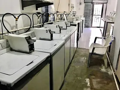 a row of sinks in a room with chairs at Miami Studios DR in Santo Domingo