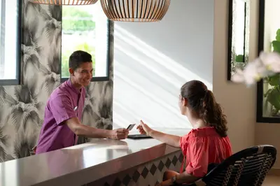 a man and a girl sitting at a counter talking at Catalonia Royal La Romana Adults Only - All Inclusive in Bayahibe