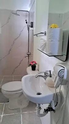 a bathroom with a sink and a toilet and a mirror at Riviera Punta Cana Eco Travelers in Punta Cana