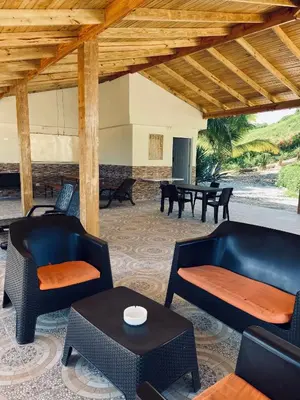 a living room with chairs and a table at Hotel Al Mare in Santa Cruz de Barahona