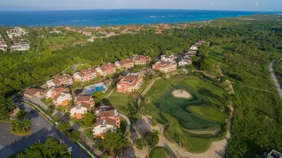 an aerial view of a mansion with a golf course at Tot Punta Cana Apartments in Punta Cana