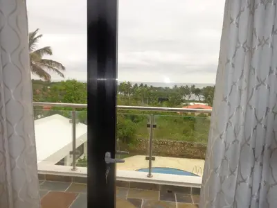 a view from the window of a balcony at White House Mansion in San Felipe de Puerto Plata