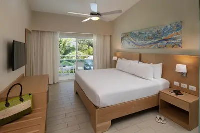 a bedroom with a large bed and a television at Lifestyle Tropical Beach Resort & Spa All Inclusive in San Felipe de Puerto Plata