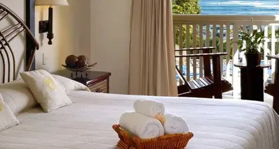 a bedroom with a white bed with towels on it at Lifestyle Tropical Beach Resort & Spa All Inclusive in San Felipe de Puerto Plata