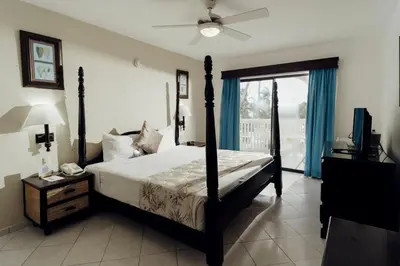 a bedroom with a bed with a fan and a window at Lifestyle Tropical Beach Resort & Spa All Inclusive in San Felipe de Puerto Plata