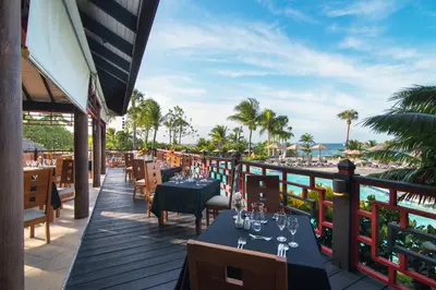 a restaurant with tables and chairs and a view of the ocean at Lifestyle Tropical Beach Resort & Spa All Inclusive in San Felipe de Puerto Plata