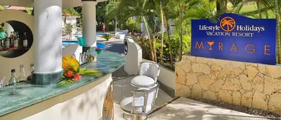 a bar at a resort with a sign that reads embassy at Lifestyle Crown Residence Suites in San Felipe de Puerto Plata