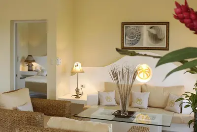 a living room with a couch and a table at Lifestyle Crown Residence Suites in San Felipe de Puerto Plata