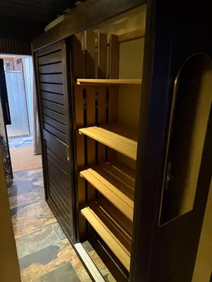 a black cabinet with wooden shelves in a room at Sosua Inn Hotel in Sosúa
