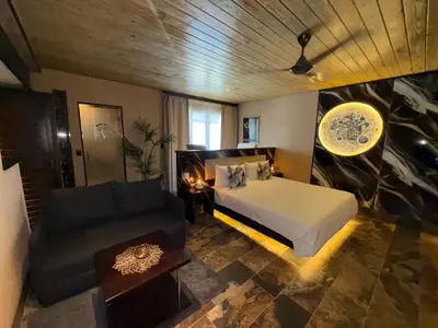 a bedroom with a bed and a couch at Sosua Inn Hotel in Sosúa