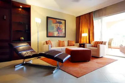 a living room with a couch and a chair at Presidential Suites by Lifestyle Puerto Plata - All Inclusive in San Felipe de Puerto Plata