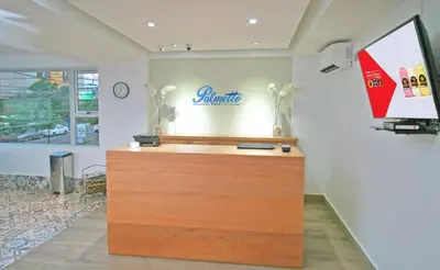 a cash register in a store with a sign on the wall at Palmetto Hotel in Santiago de los Caballeros