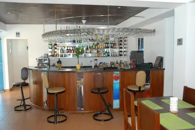 a bar in a restaurant with chairs around it at Anton Reef in Sosúa