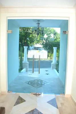 a view through a glass door into a courtyard at Anton Reef in Sosúa
