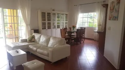 a living room with a couch and a table at Hispaniola Residencial private villas in Sosúa