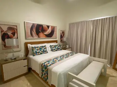 a bedroom with a bed and a chair and a window at Hispaniola Residencial private villas in Sosúa