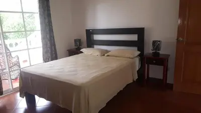 a bedroom with a bed with two pillows on it at Hispaniola Residencial private villas in Sosúa