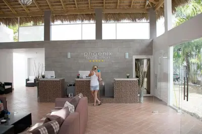 a woman standing at a counter in a lobby at El Cabarete Spa Resort all-Inclusive in Cabarete