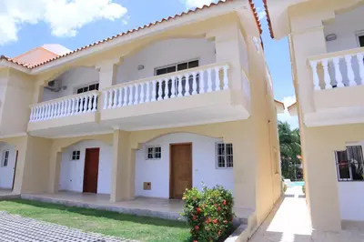 a house with a balcony on the side of it at Residencial Las Estrellas in Boca Chica