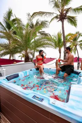 a man and a woman sitting in a hot tub at Boca Beach Residence hotel in Boca Chica