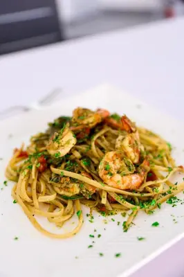 a plate of shrimp pasta on a white plate at Boca Beach Residence hotel in Boca Chica
