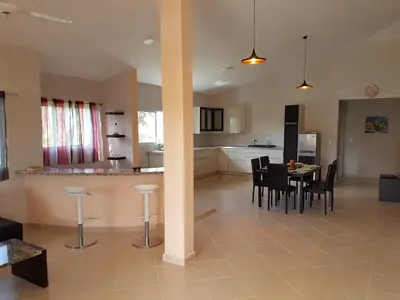 a kitchen and dining room with a table and chairs at Caleton Group in Río San Juan