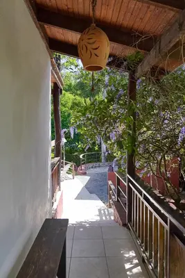 a porch with a bench and a hanging light at Villa Bayacanes con piscinas privadas in Jarabacoa