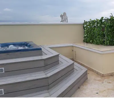 a balcony with stairs and an elephant statue on the roof at Villa Florencia in Boca Chica